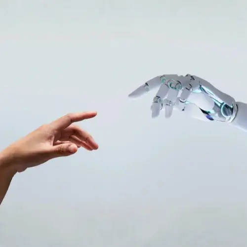 Human hand reaching out to AI robot